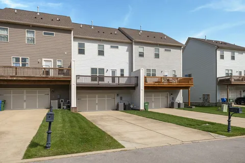 a front view of a house with a garden and plants