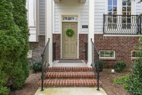 a view of front door of house with potted plants