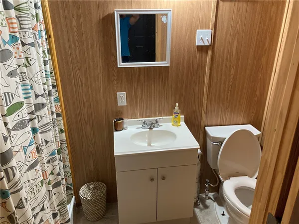 a bathroom with a sink toilet and mirror