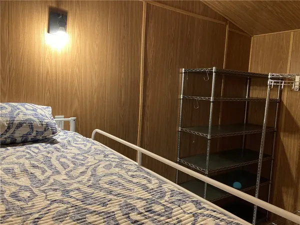 a bedroom with a bed and a mirror