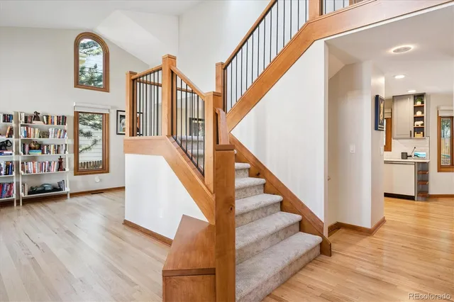 a view of entryway and hall with wooden floor
