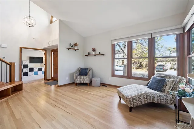 a spacious bedroom with a balcony a bed and a large window