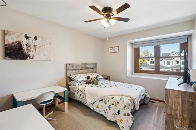 a bedroom with a bed a couch and a window