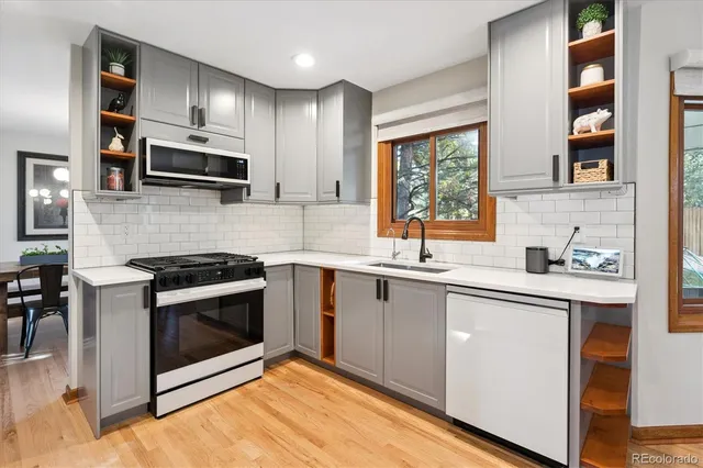 a kitchen with stainless steel appliances white cabinets and a sink