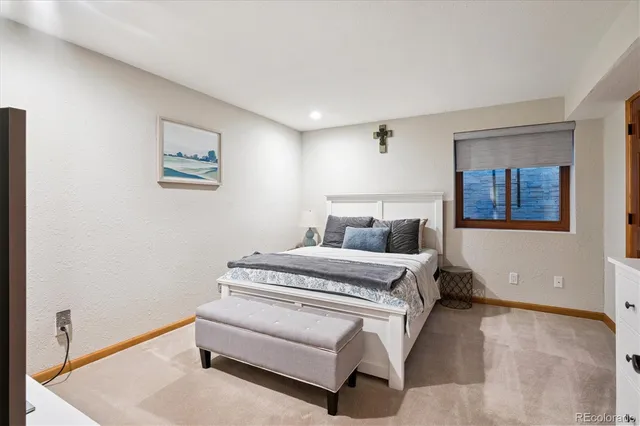 a spacious bedroom with a bed and a cabinets