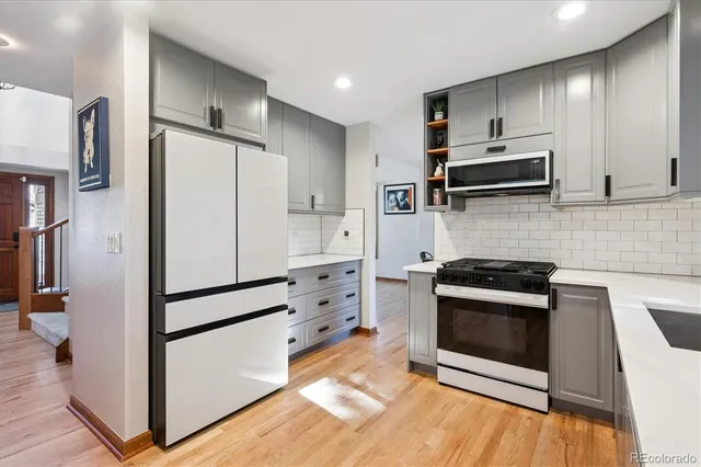 a kitchen with stainless steel appliances a refrigerator stove and microwave