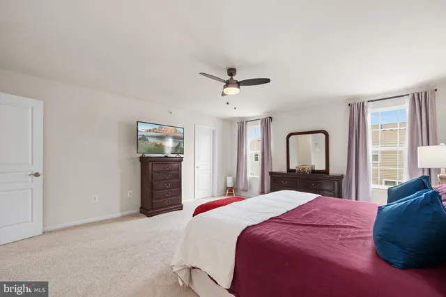 a spacious bedroom with a bed and a chandelier