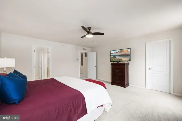 a bed sitting in a bedroom and a large mirror