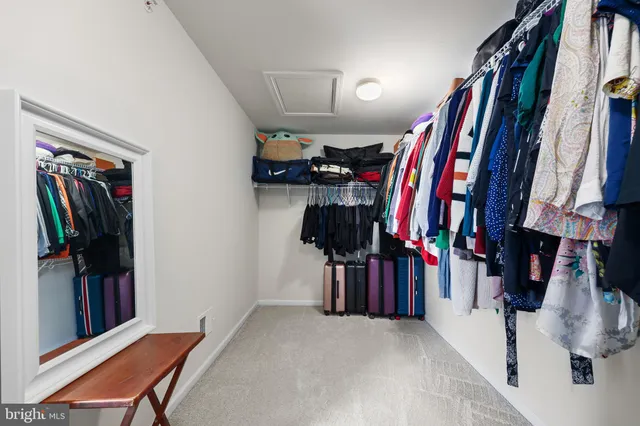 a spacious bedroom with a bed and a chandelier