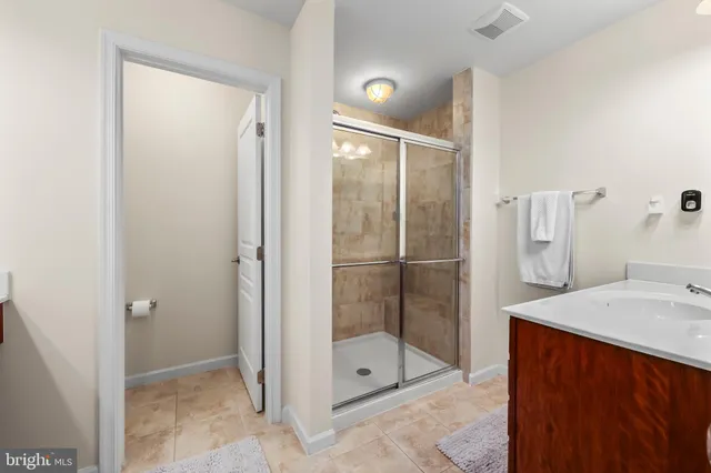 a bathroom with a sink vanity and a mirror