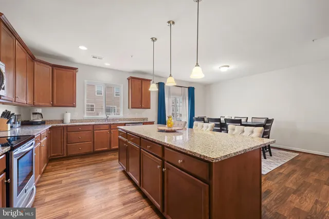 a kitchen with a sink stove and wooden cabinets