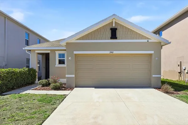 a front view of a house with garage
