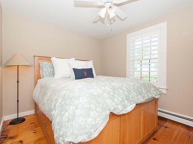 7 Hammock Pond Road Mashpee, MA 02649 - Photo 3 of 14 a bed sitting in a bedroom next to a window