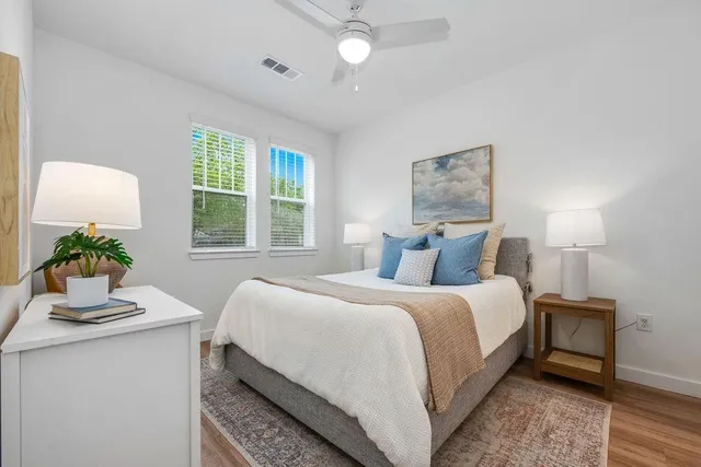 a bedroom with a bed and a window