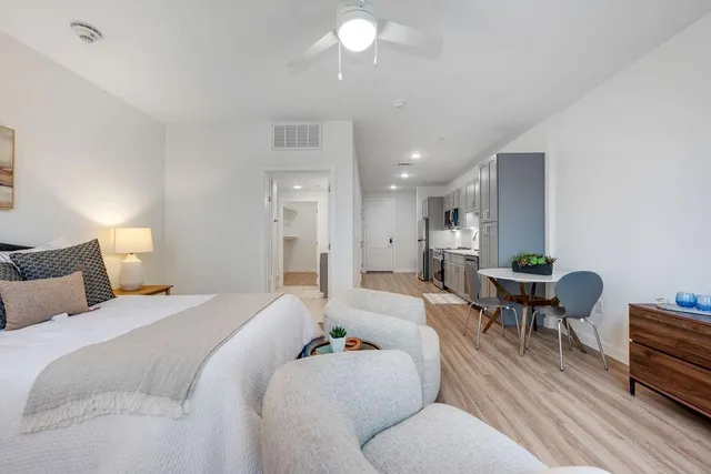 a spacious bedroom with a bed and furniture