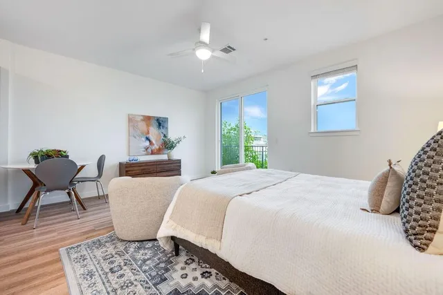 a bed room with a bed and a chair