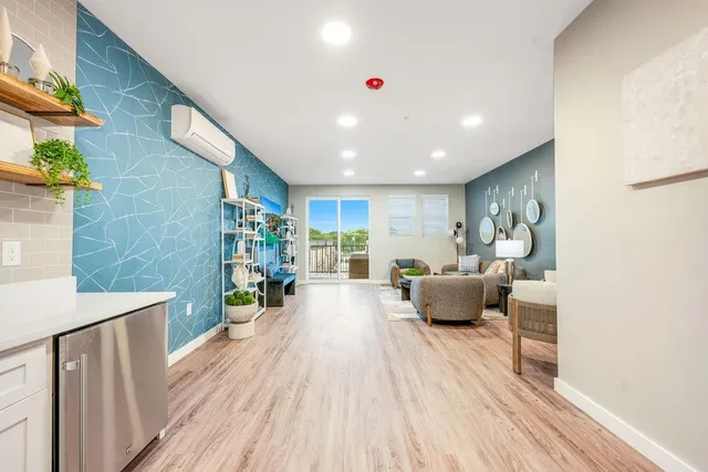 a living room with furniture and a rug