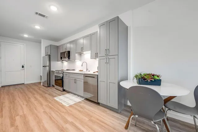 a kitchen with a refrigerator and a sink