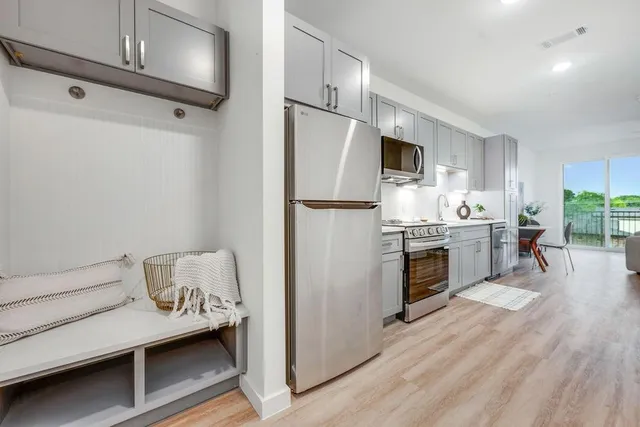 a kitchen with refrigerator cabinets and wooden floor