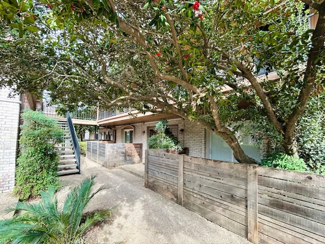 a view of a house with a tree in the background
