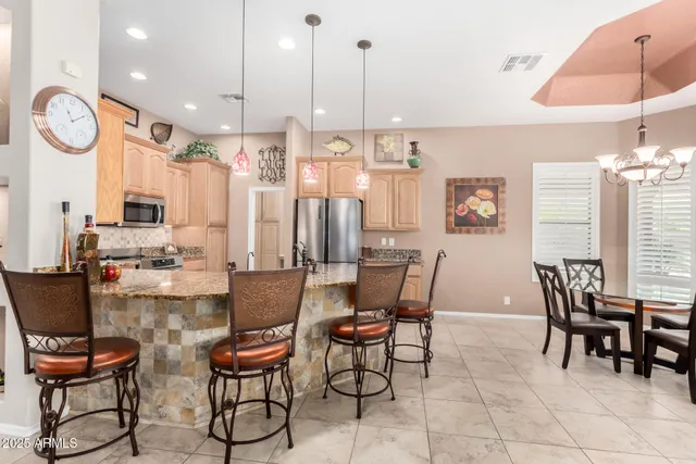 a large kitchen with a large counter top appliances and cabinets