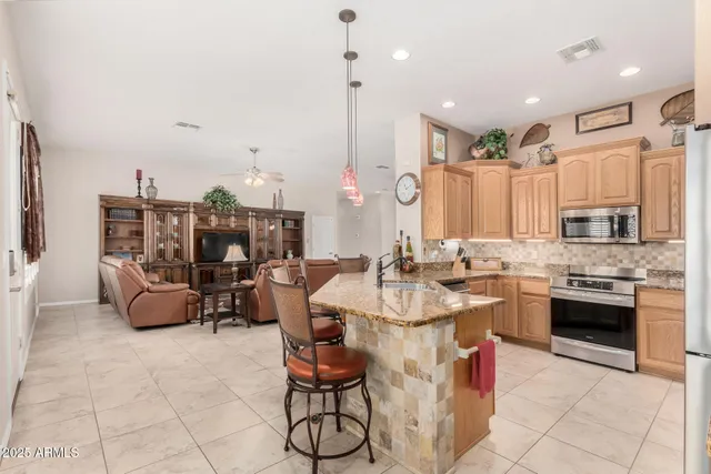 a kitchen with a granite countertop sink and a window