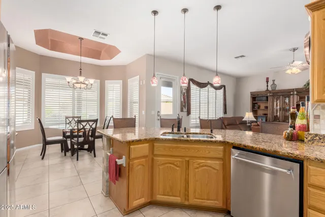 a kitchen with stainless steel appliances granite countertop a refrigerator and cabinets