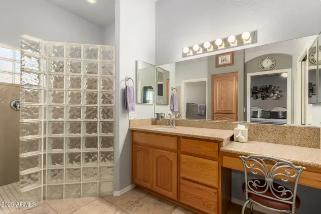 a bedroom with a bed and a dresser with mirror