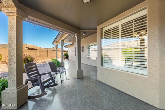 a view of a patio with a table and chairs