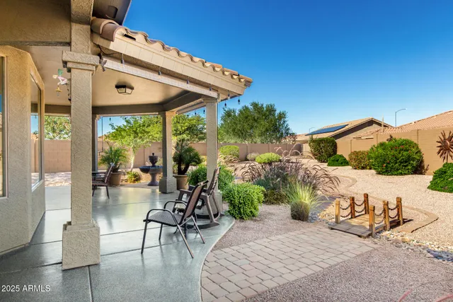 a front view of a house with a yard and potted plants