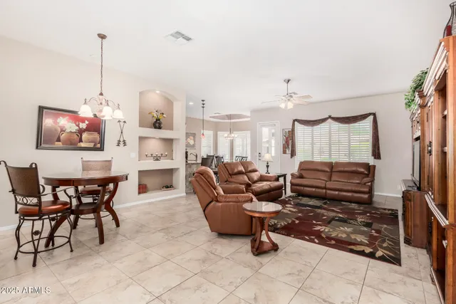 a view of a dining room with furniture and a chandelier