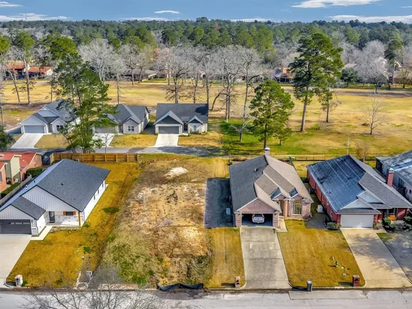 an aerial view of residential houses with outdoor space and swimming pool