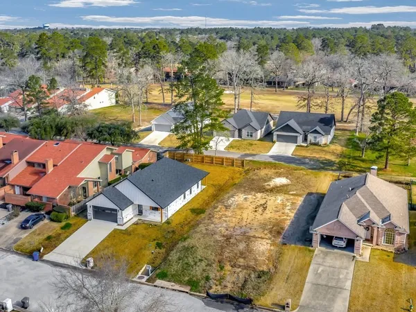 an aerial view of residential houses with outdoor space and swimming pool