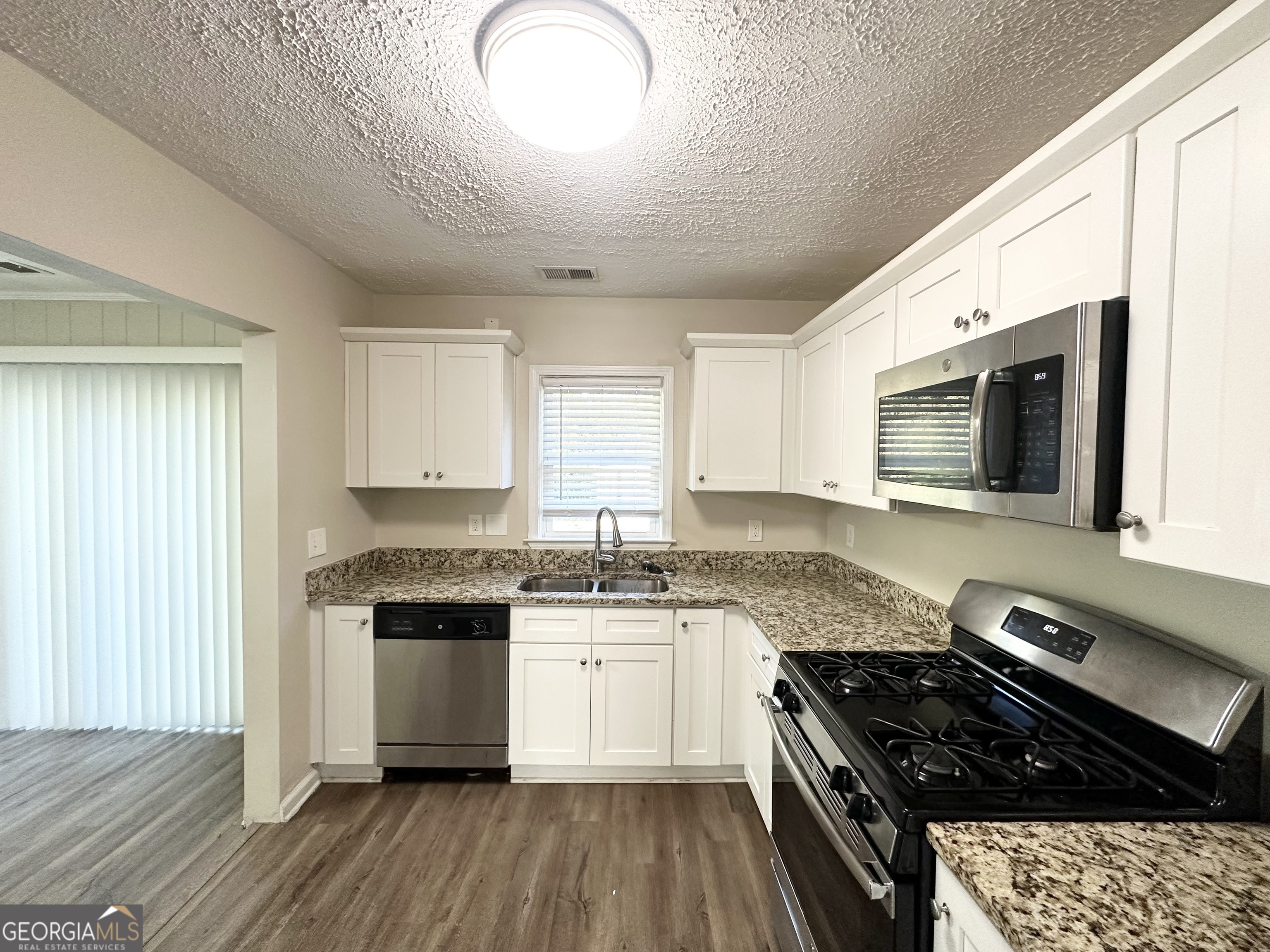 3438 Maryvale Drive Decatur, GA 30032 - Photo 4 of 13 a kitchen with stainless steel appliances granite countertop a stove a sink and a microwave
