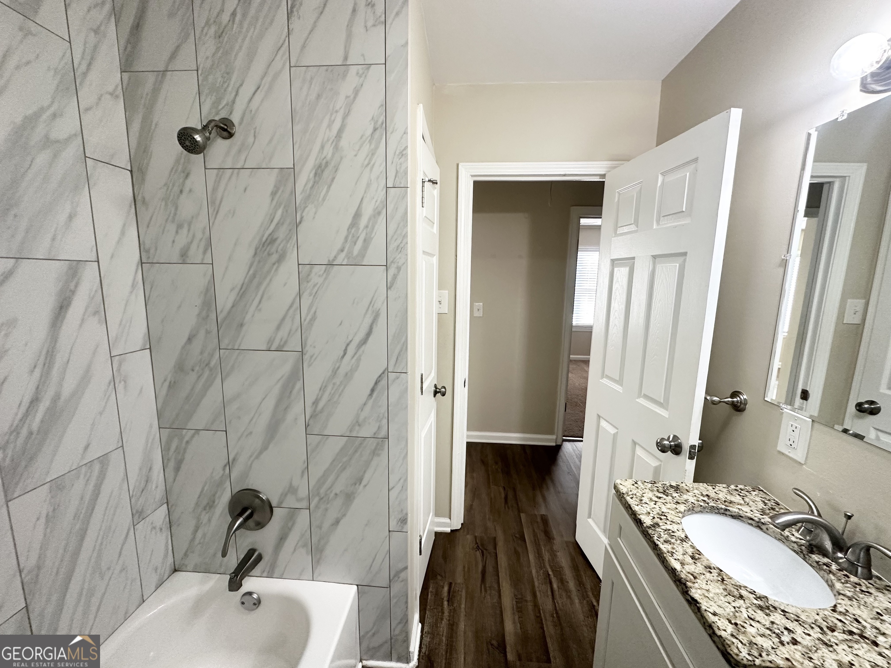 3438 Maryvale Drive Decatur, GA 30032 - Photo 9 of 13 a bathroom with a granite countertop sink a mirror and shower
