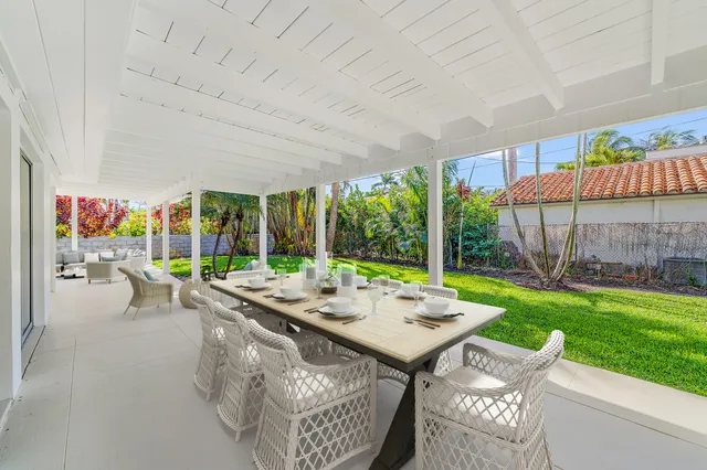 a view of a patio with a table chairs and backyard