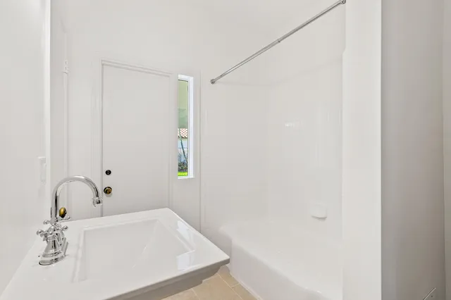 a bathroom with a tub and a sink