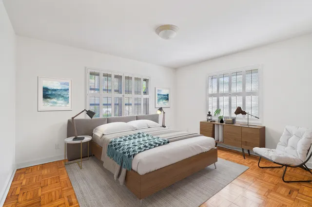 a bedroom with a large bed and a window