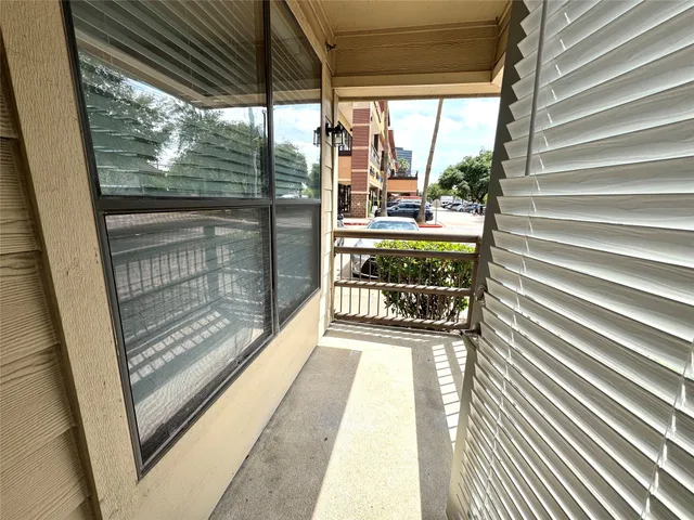 a view of kitchen with stainless steel appliances kitchen island wooden floor and window