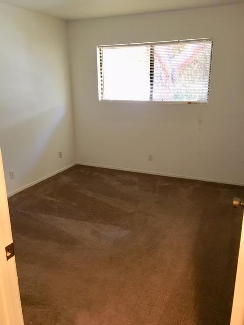 4409 Catlin Circle, Unit B Carpinteria, CA 93013 - Photo 12 of 13 an empty room with wooden floor and windows