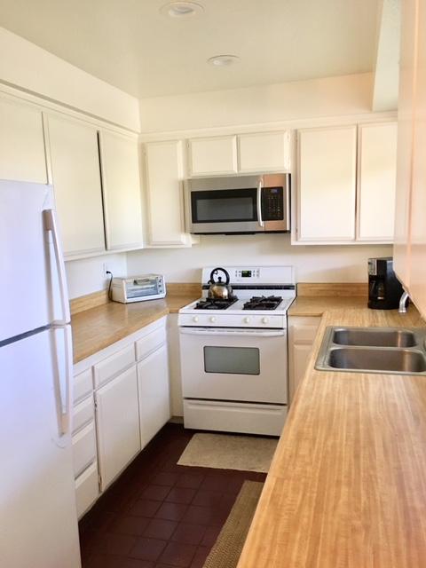 4409 Catlin Circle, Unit B Carpinteria, CA 93013 - Photo 2 of 13 a kitchen with stainless steel appliances a stove a sink and a microwave