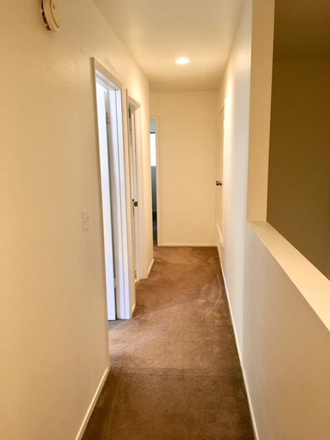4409 Catlin Circle, Unit B Carpinteria, CA 93013 - Photo 8 of 13 a view of a hallway with wooden floor and a bathroom