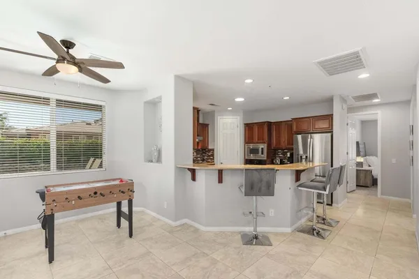a living room with kitchen furniture and a window