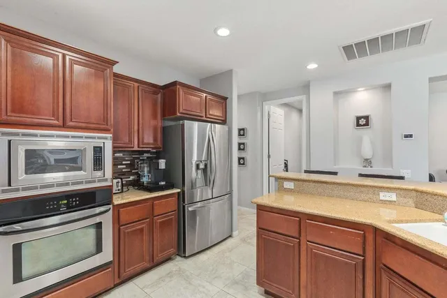 a kitchen with a sink stove and refrigerator
