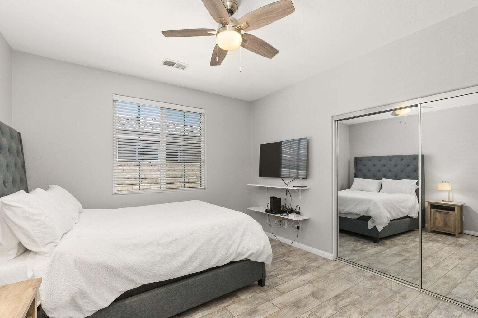 83631 Himalaya Drive Indio, CA 92203 - Photo 22 of 36 a bedroom with a bed window and a flat screen tv