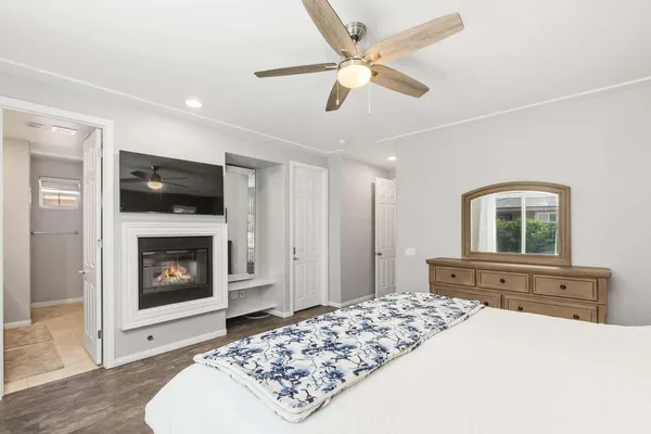 a bedroom with a bed and a fireplace