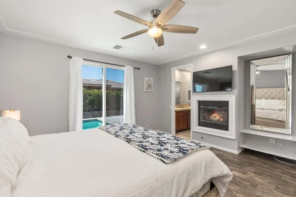 a bedroom with a large bed and a fireplace