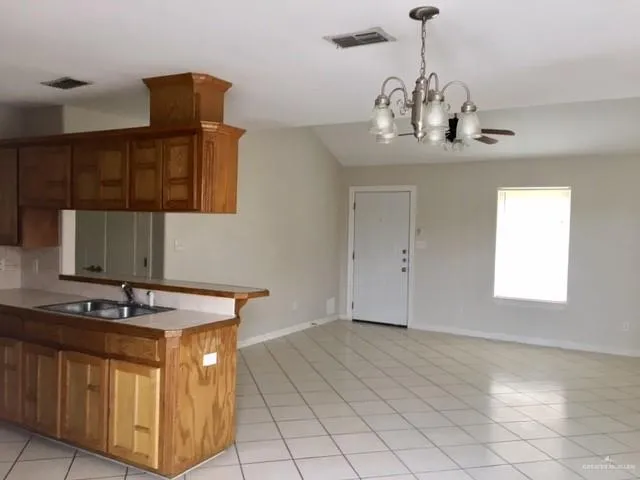 a kitchen with stainless steel appliances granite countertop a sink and a stove