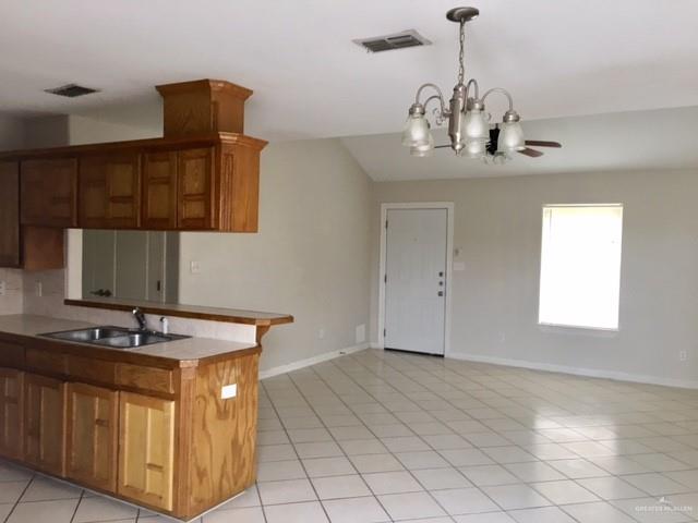 1606 East Quail Street Pharr, TX 78577 - Photo 3 of 10 a kitchen with stainless steel appliances granite countertop a sink and a stove