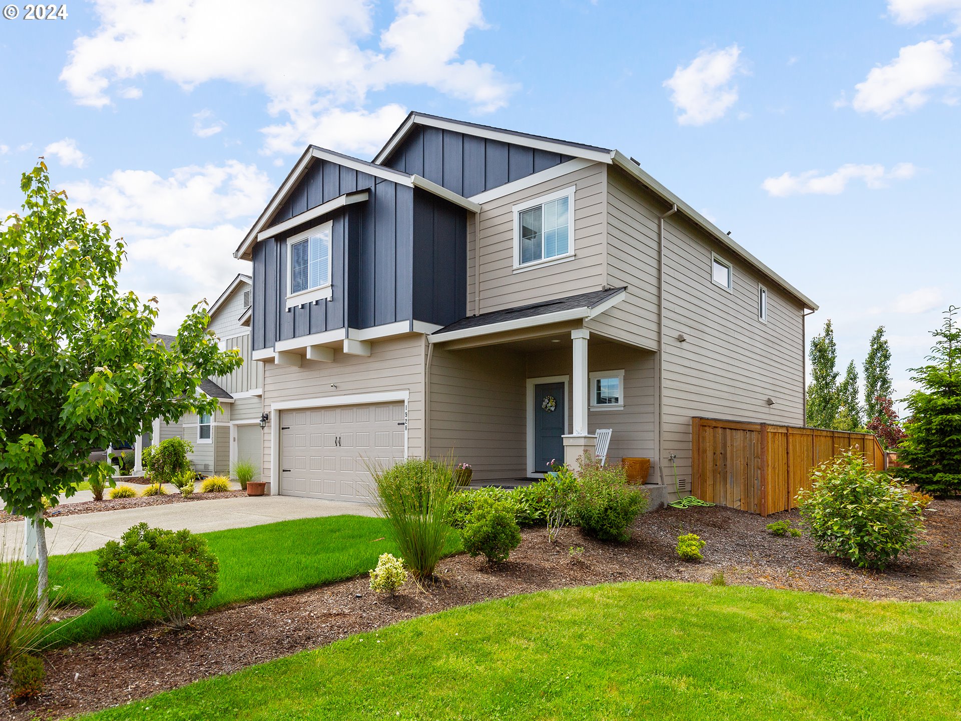 1928 South Robin Way Ridgefield, WA 98642 - Photo 1 of 27 a front view of a house with a garden and plants